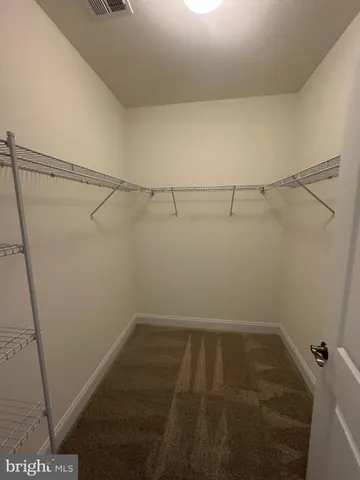 a spacious bathroom with a double vanity sink a mirror and a shower