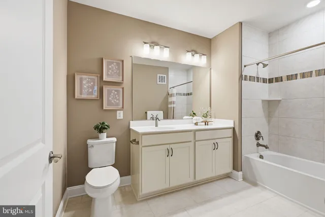 a bathroom with a sink toilet mirror and bathtub