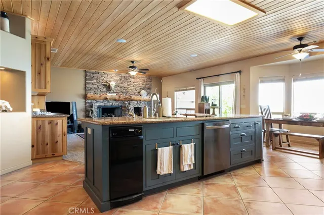 a kitchen with stainless steel appliances granite countertop a stove a sink dishwasher and a refrigerator