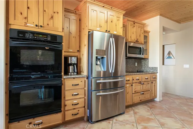 a kitchen with stainless steel appliances granite countertop a stove microwave and refrigerator