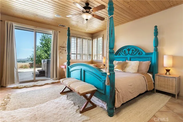 a bedroom with a bed lamp and window