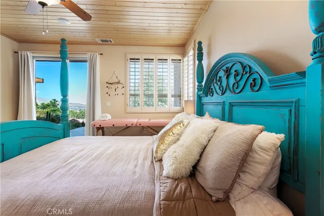 a bed sitting in a bedroom next to a window