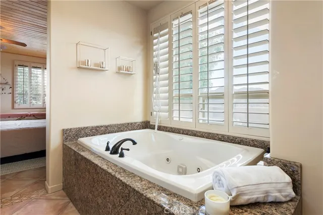 a bathroom with bathtub and window
