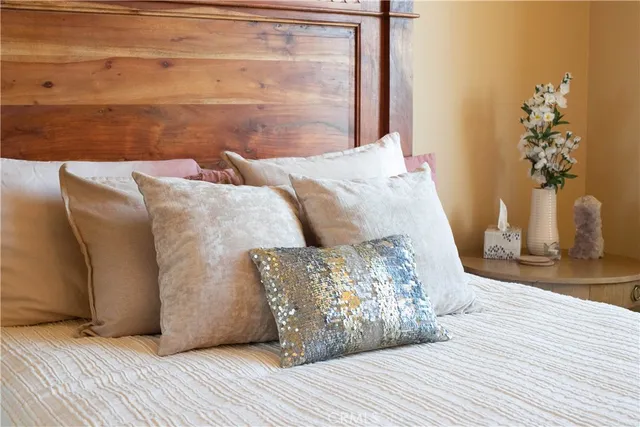 a bed sitting in a bedroom next to a large window