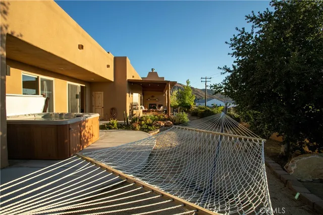 a view of a patio with dining table and chairs with wooden floor and fence