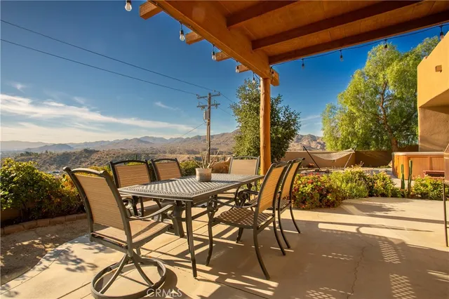 a view of a patio with table and chairs and potted plants