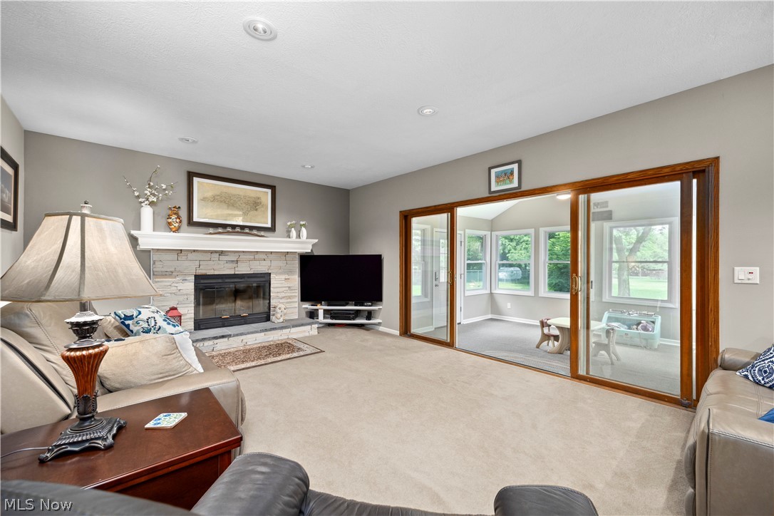 3270 North Ridge Road Vermilion, OH 44089 - Photo 19 of 49 Living area with a stone-clad fireplace, white mantel, and recessed lighting