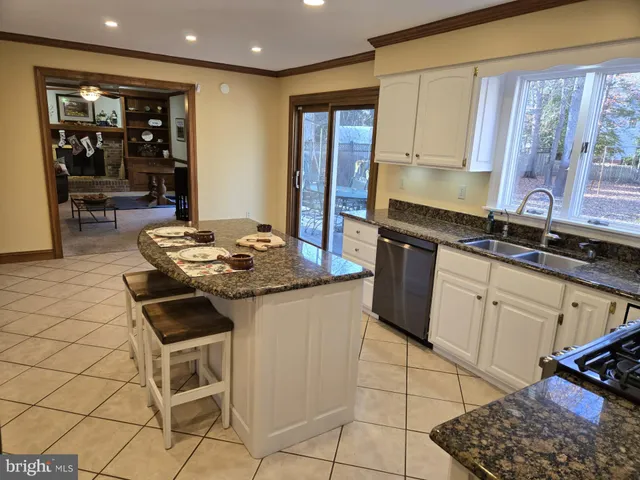 a living room with a bed furniture and a window