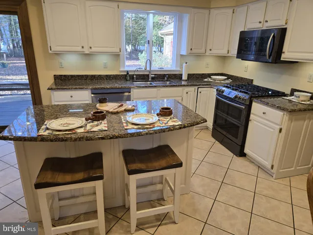 a bedroom with a bed and flat screen tv