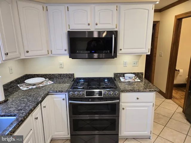 a bedroom with furniture and a ceiling fan