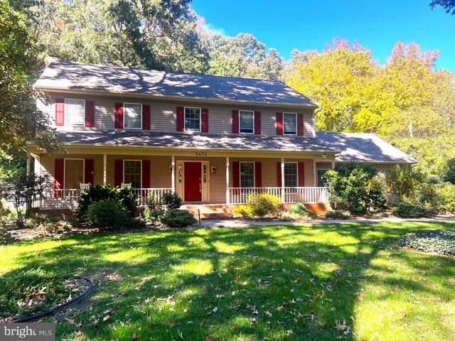 a living room with furniture a flat screen tv and a floor to ceiling window