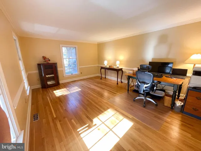 a living room with stainless steel appliances with a rug