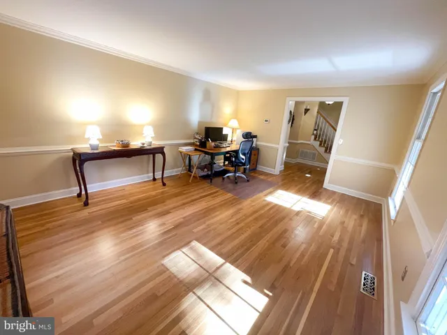 a living room with furniture a large window and a rug