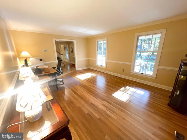 a living room with furniture a flat screen tv and a window