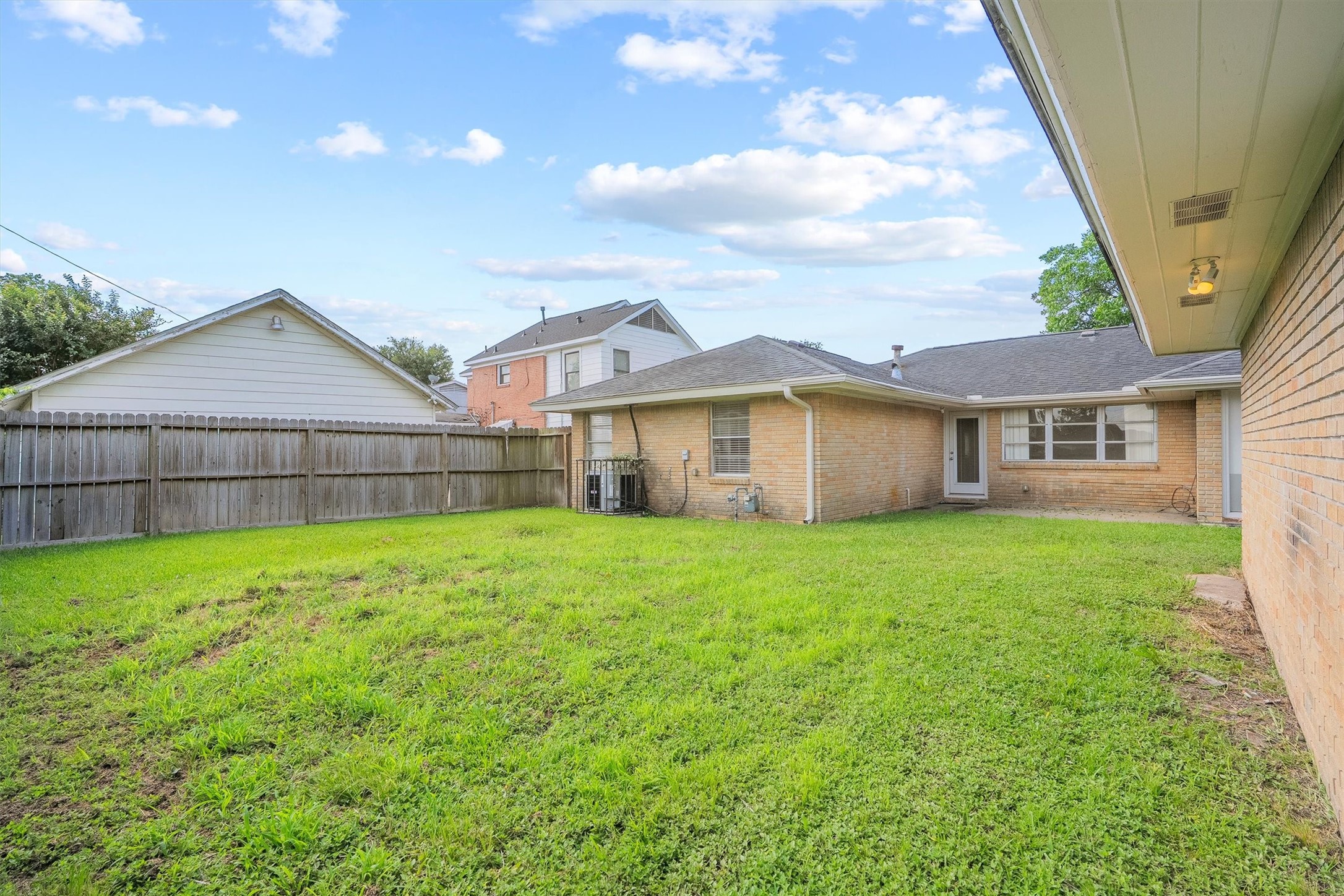 3331 Arbor Street Houston, TX 77004 - Photo 28 of 30 This photo showcases a spacious backyard with a well-maintained lawn, surrounded by a wooden fence.