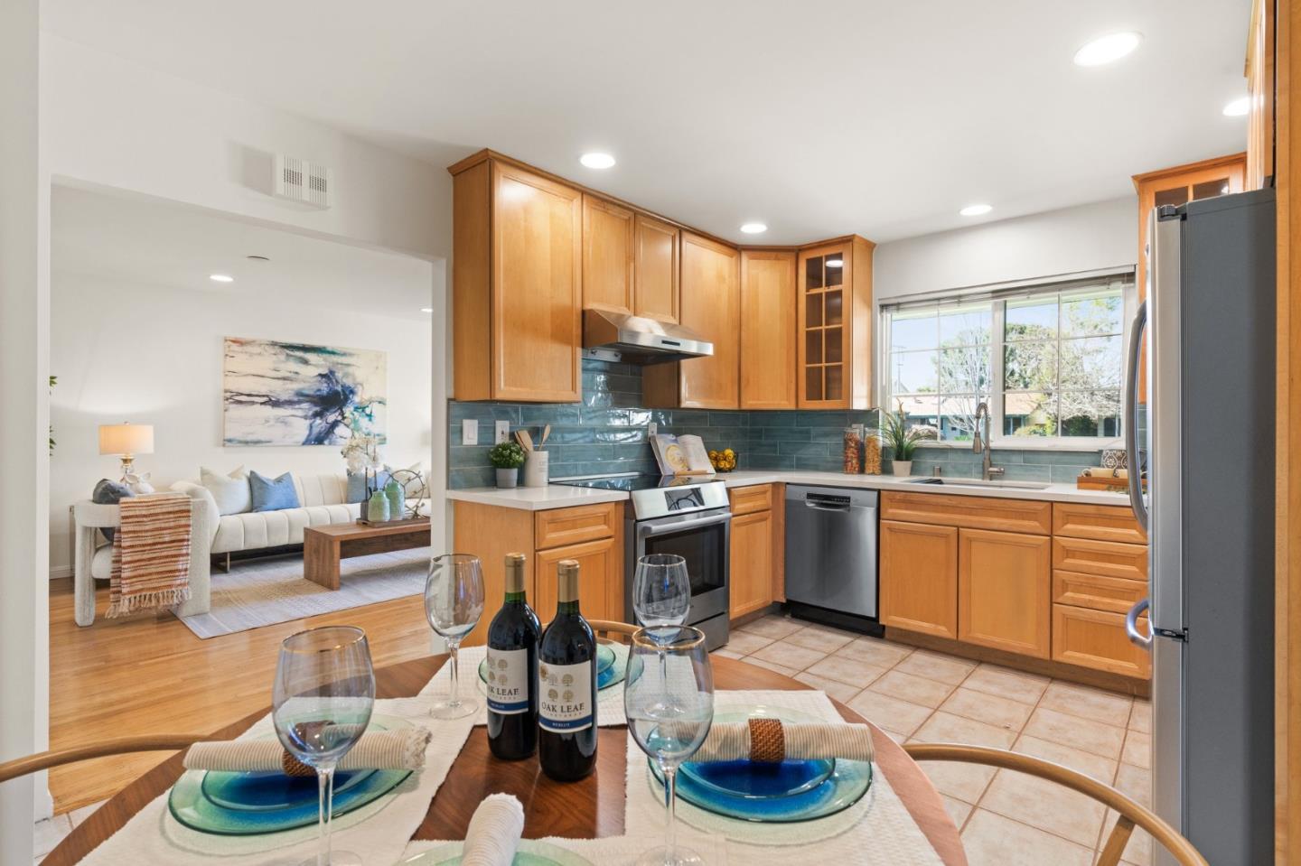 1332 Poe Lane San Jose, CA 95130 - Photo 11 of 32 a kitchen with stainless steel appliances granite countertop a sink a stove a refrigerator cabinets and living room view