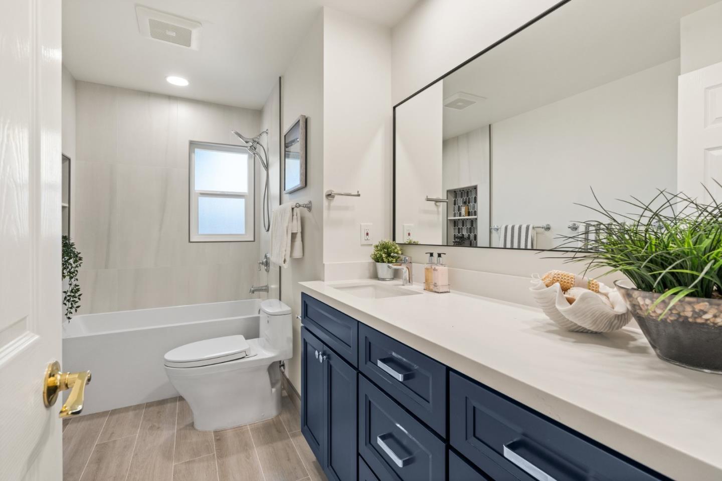 1332 Poe Lane San Jose, CA 95130 - Photo 15 of 32 a spacious bathroom with a granite countertop sink a toilet a mirror and shower