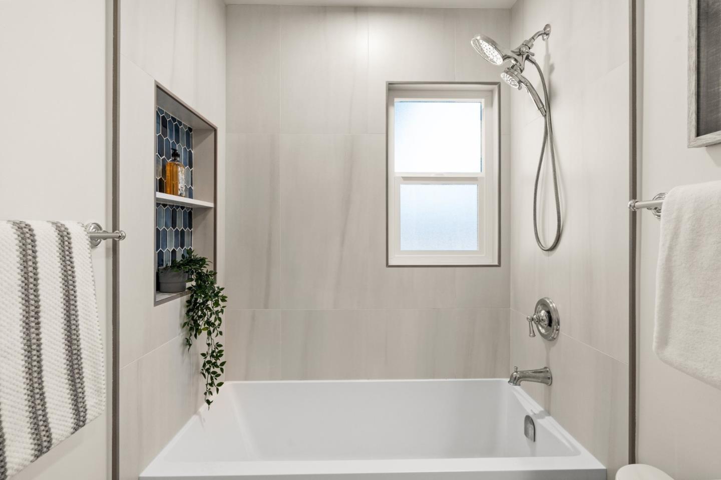 1332 Poe Lane San Jose, CA 95130 - Photo 17 of 32 a bathroom with a tub shower and a sink