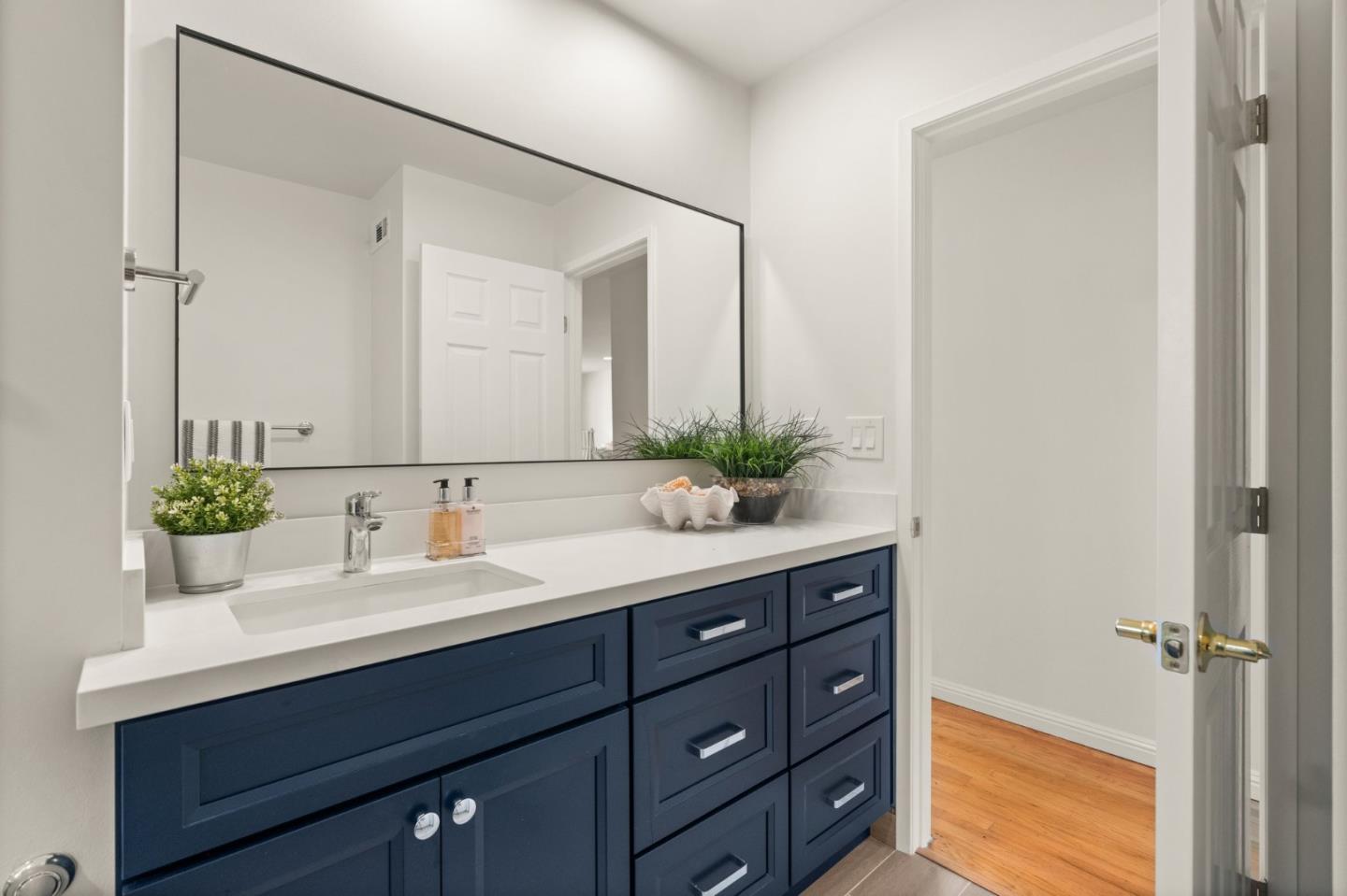 1332 Poe Lane San Jose, CA 95130 - Photo 18 of 32 a bathroom with a sink vanity granite and a mirror