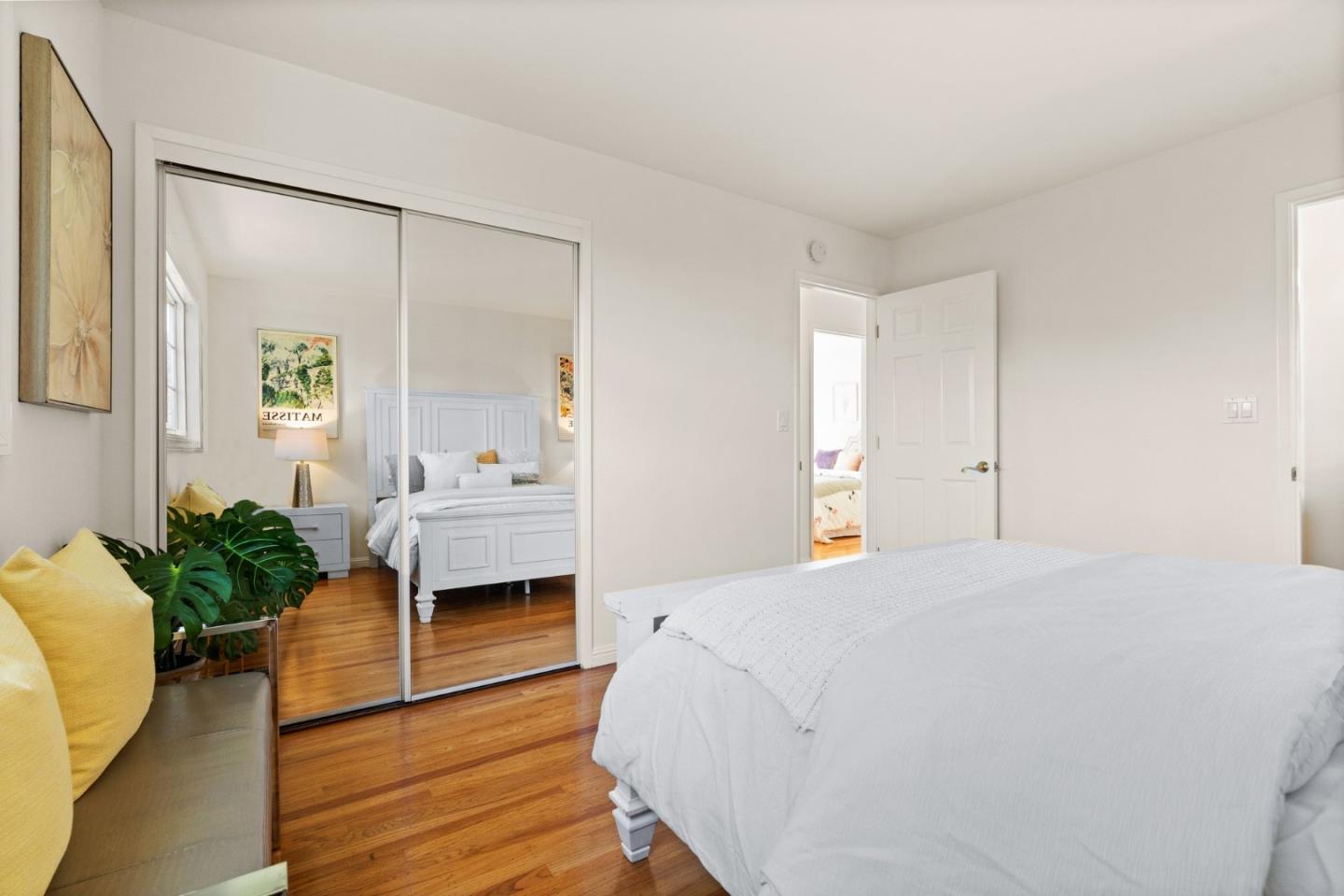 1332 Poe Lane San Jose, CA 95130 - Photo 21 of 32 a spacious bedroom with a bed and a potted plant