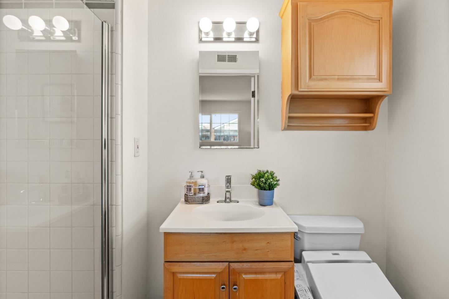 1332 Poe Lane San Jose, CA 95130 - Photo 22 of 32 a bathroom with a sink a toilet and mirror