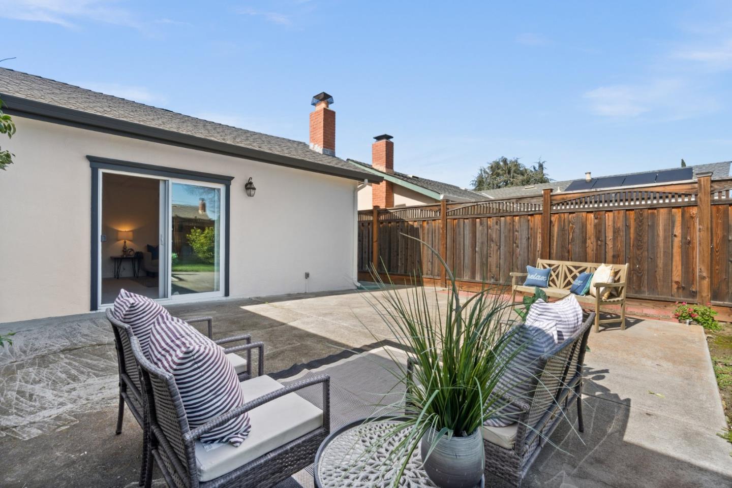 1332 Poe Lane San Jose, CA 95130 - Photo 26 of 32 a view of a patio with table and chairs with wooden fence