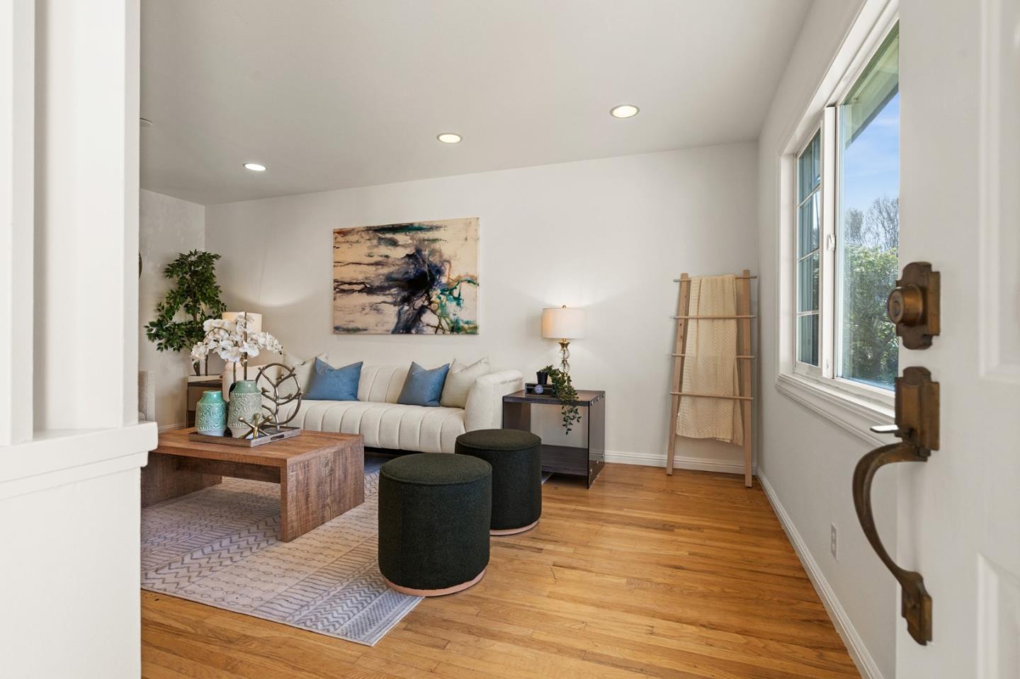 1332 Poe Lane San Jose, CA 95130 - Photo 3 of 32 a living room with furniture a large window and wooden floor