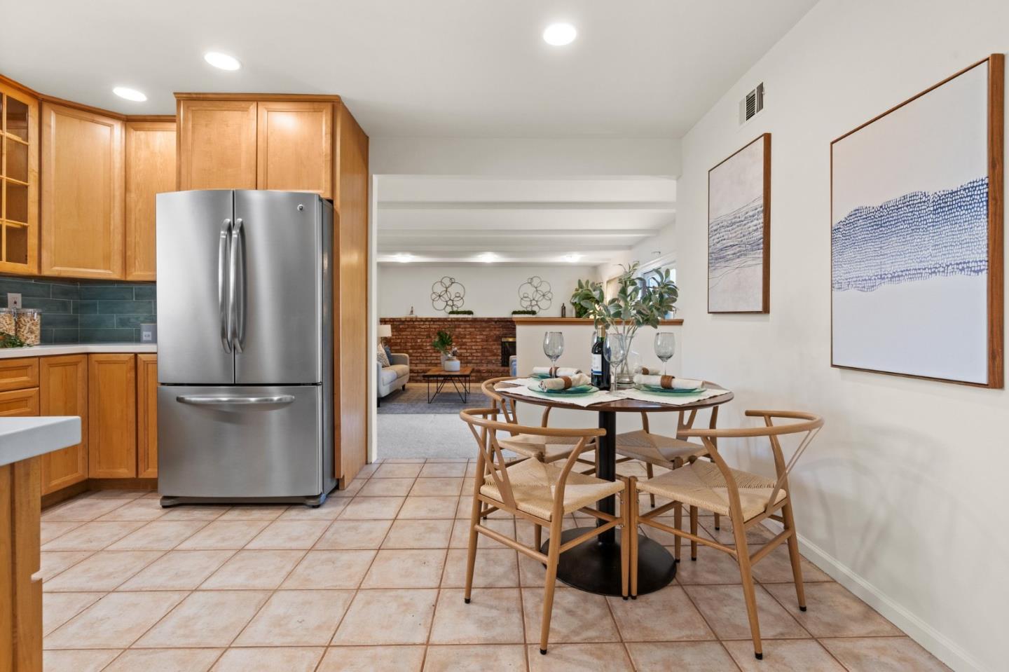 1332 Poe Lane San Jose, CA 95130 - Photo 8 of 32 a kitchen with stainless steel appliances a refrigerator a stove a sink and a dining table