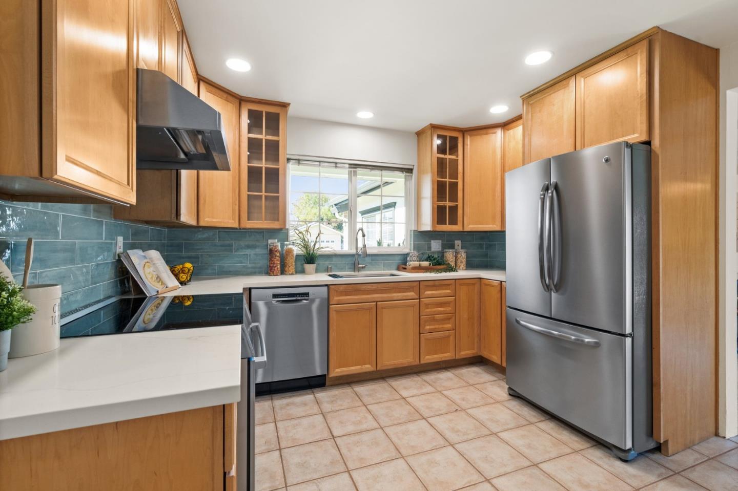 1332 Poe Lane San Jose, CA 95130 - Photo 9 of 32 a kitchen with granite countertop a refrigerator and a sink