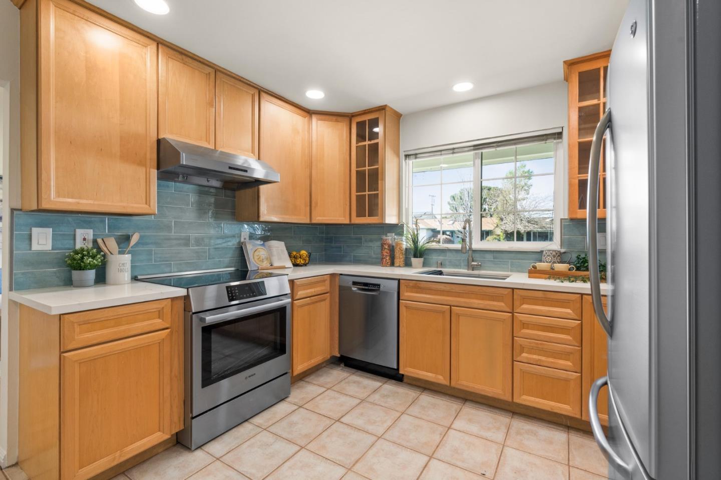 1332 Poe Lane San Jose, CA 95130 - Photo 10 of 32 a kitchen with granite countertop cabinets stainless steel appliances a sink and a window