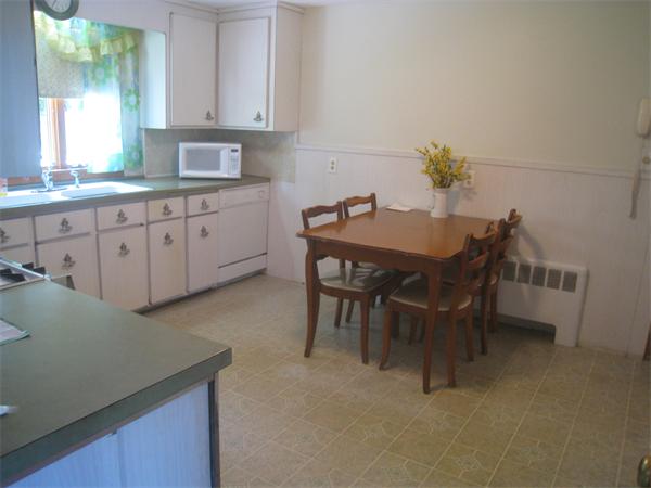 6 Virginia Road Arlington, MA 02476 - Photo 8 of 18 a kitchen with granite countertop a table chairs sink and cabinets