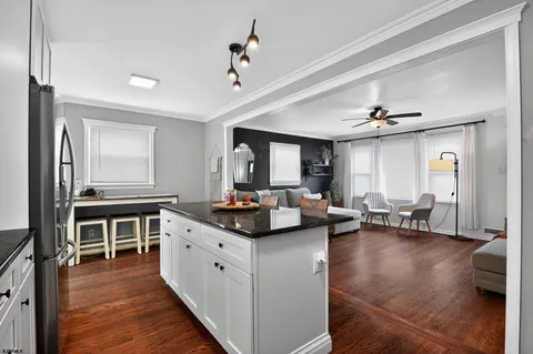 a kitchen with sink refrigerator and cabinets
