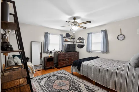 a bedroom with a bed a couch and dresser