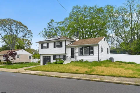 a view of house that has a yard