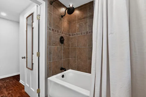 a bathroom with a tub and shower