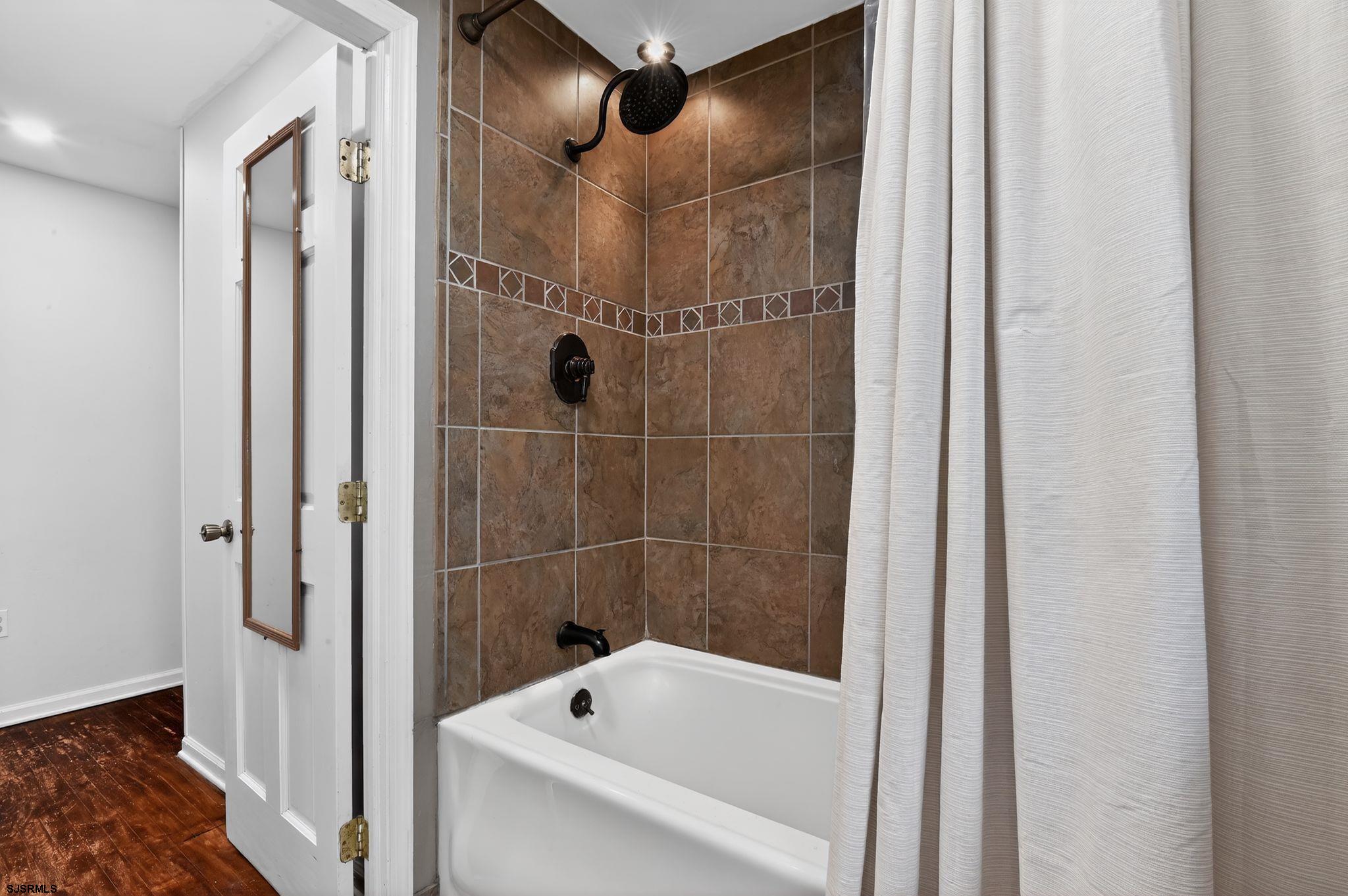 5 Merion Drive Somers Point, NJ 08244 - Photo 21 of 29 a bathroom with a tub and shower