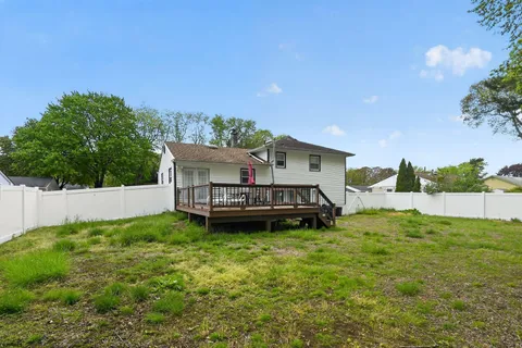 a view of a house with a yard and sitting area