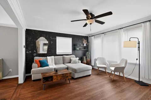 a living room with furniture and a wooden floor