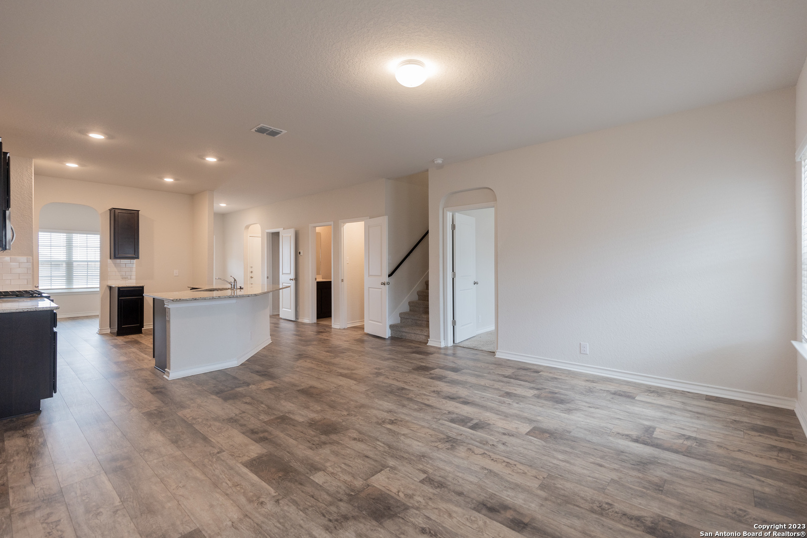 9819 Bratten Rise San Antonio, TX 78254 - Photo 8 of 37 a view of kitchen and hall with wooden floor