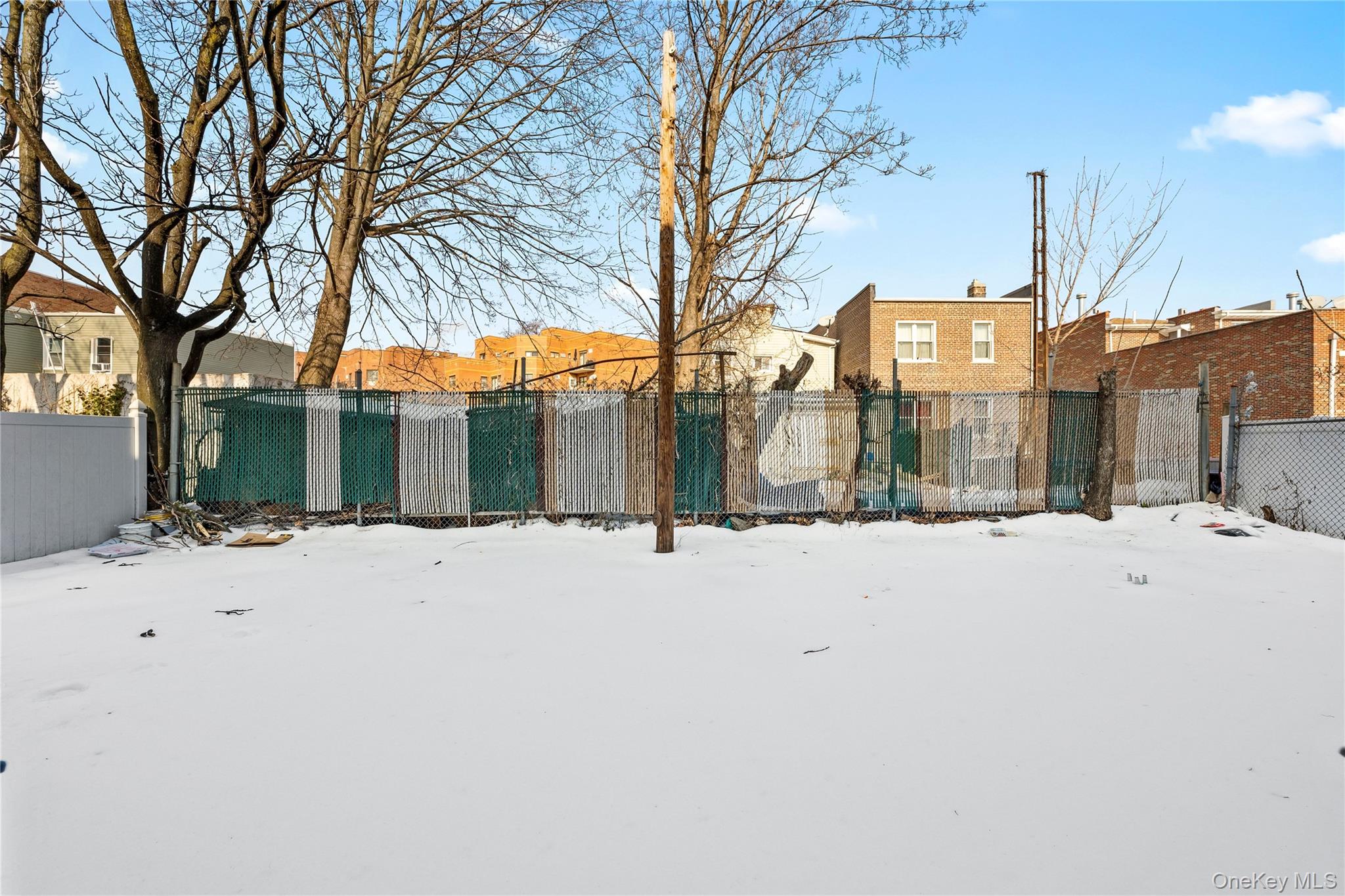 56-09 Van Cleef Street Queens, NY 11368 - Photo 13 of 14 a view of a house with snow on the road