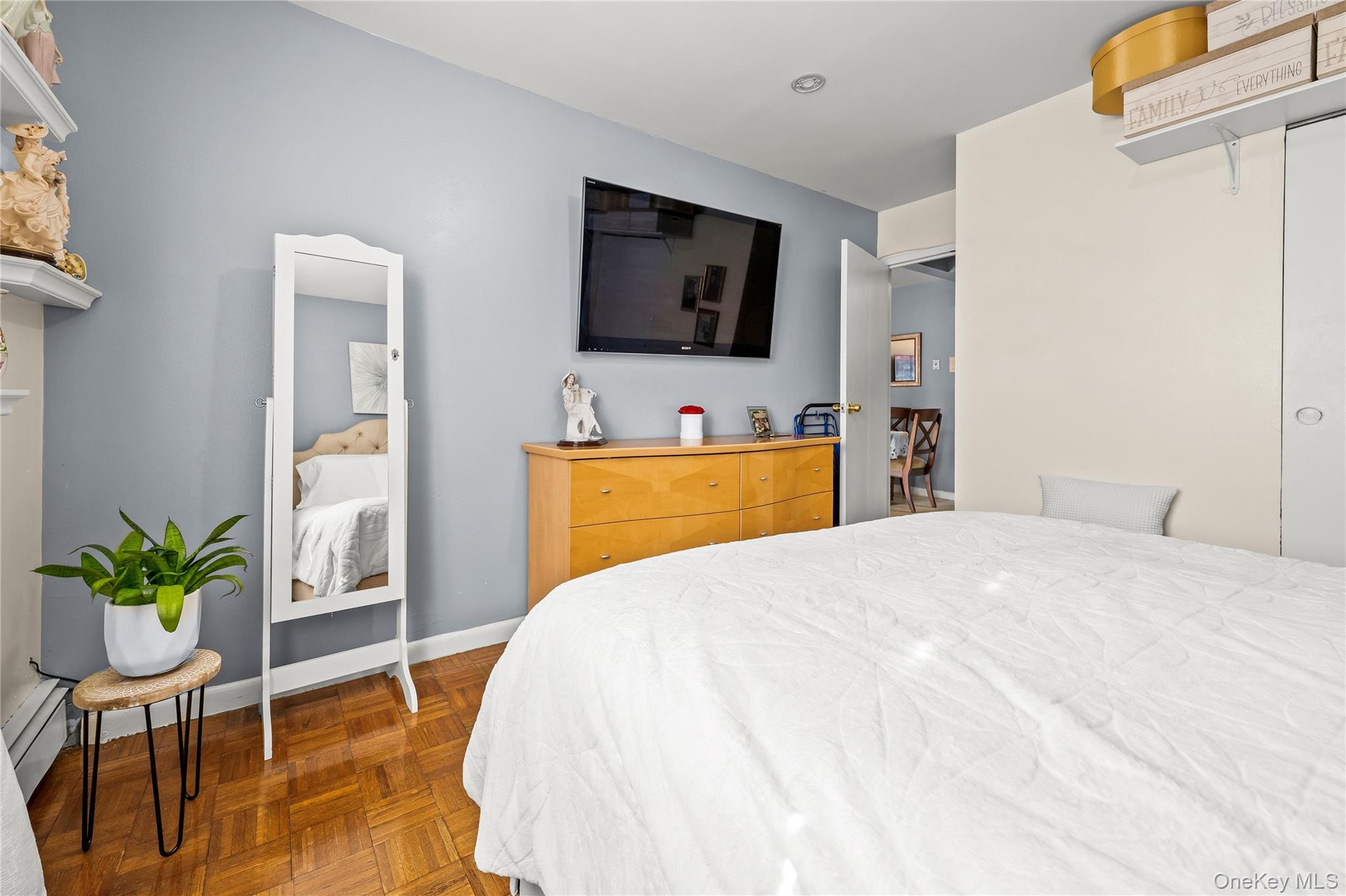 56-09 Van Cleef Street Queens, NY 11368 - Photo 2 of 14 a bedroom with a bed and a flat screen tv