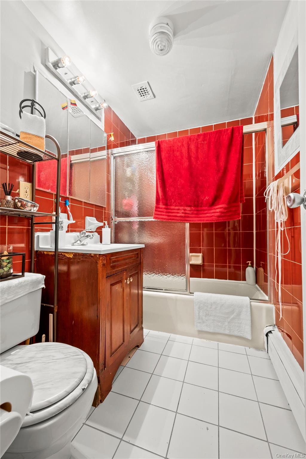 56-09 Van Cleef Street Queens, NY 11368 - Photo 7 of 14 a bathroom with a sink a toilet and shower