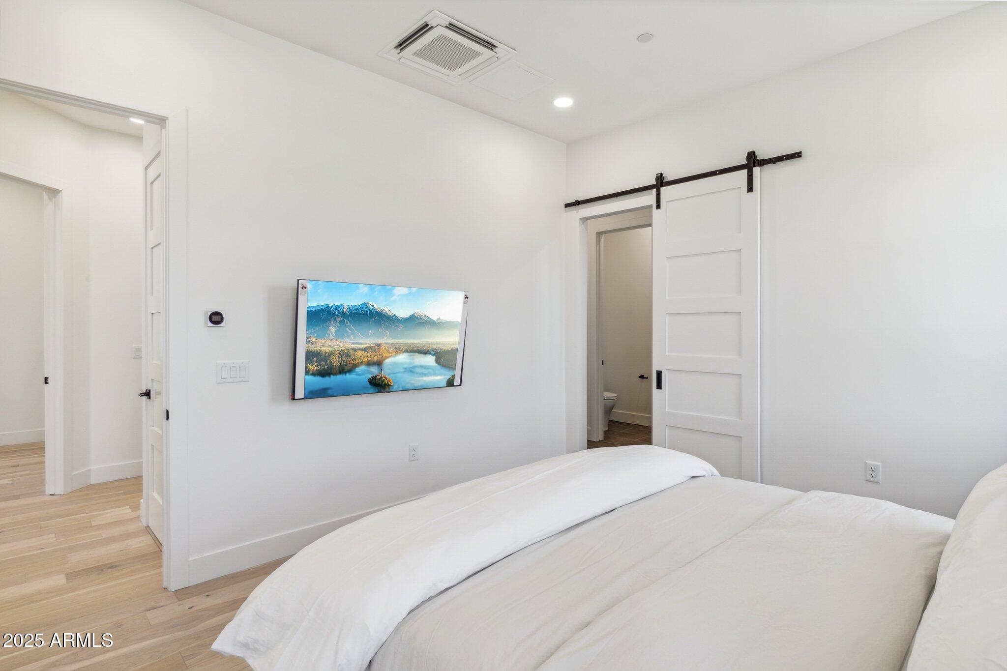 1501 North Miller Road, Unit 1016 Scottsdale, AZ 85257 - Photo 12 of 23 a bedroom with a bed and a painting on the wall