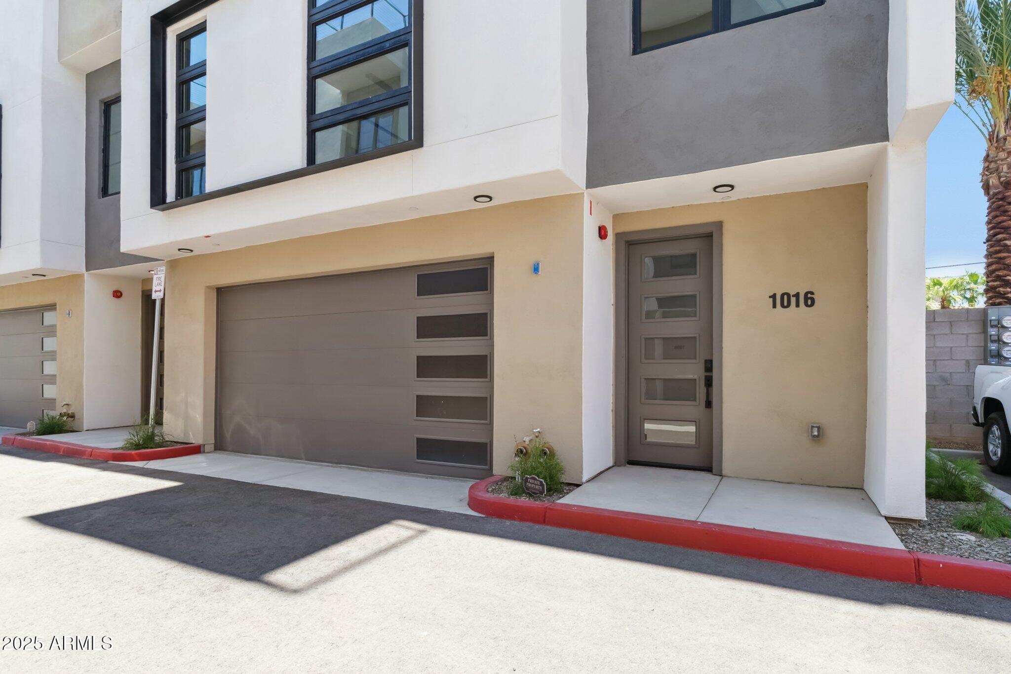 1501 North Miller Road, Unit 1016 Scottsdale, AZ 85257 - Photo 23 of 23 a view of a house with a door and a yard