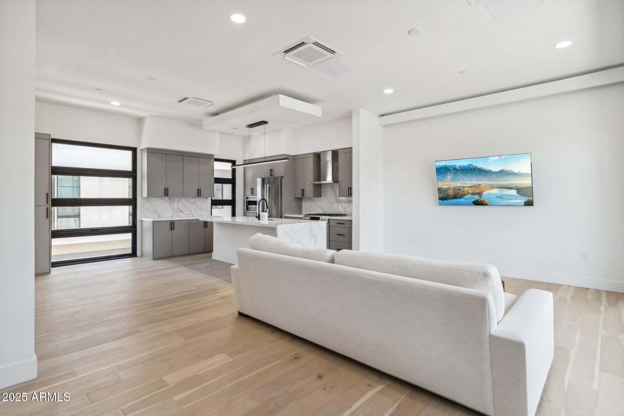 1501 North Miller Road, Unit 1016 Scottsdale, AZ 85257 - Photo 3 of 23 a living room with furniture and kitchen view
