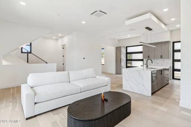 a living room with furniture and kitchen view