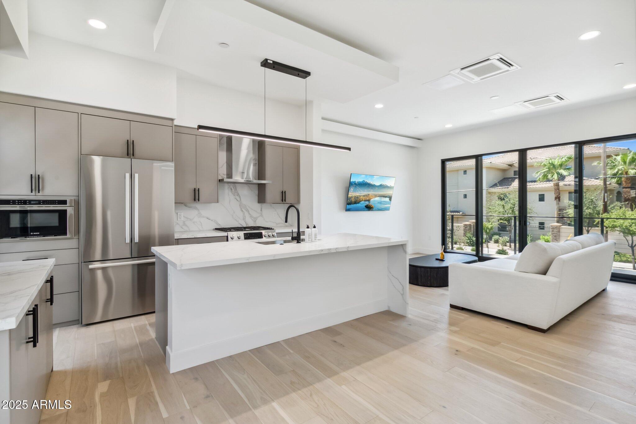 1501 North Miller Road, Unit 1016 Scottsdale, AZ 85257 - Photo 5 of 23 a living room with furniture wooden floor and large window