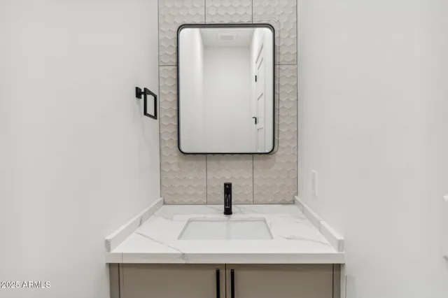 a bathroom with a sink and mirror