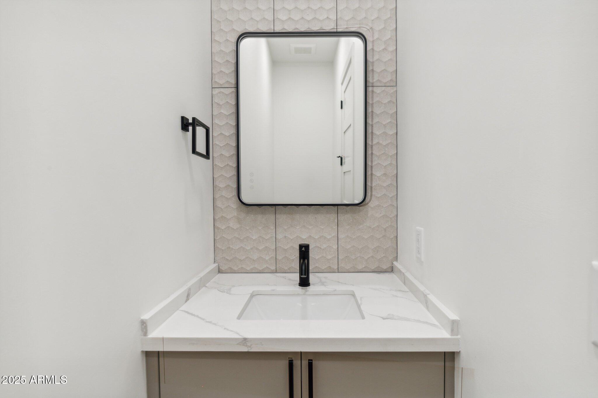 1501 North Miller Road, Unit 1016 Scottsdale, AZ 85257 - Photo 7 of 23 a bathroom with a sink and mirror