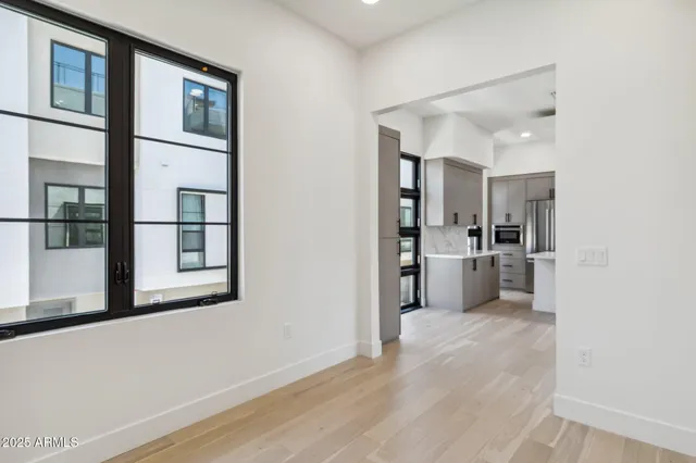 a view of a kitchen with wooden floor and a kitchen